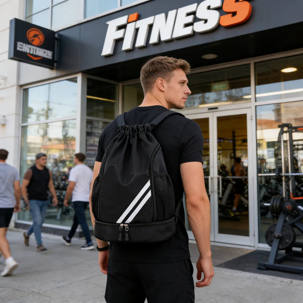 Man with a black backpack walking past a fitness center.